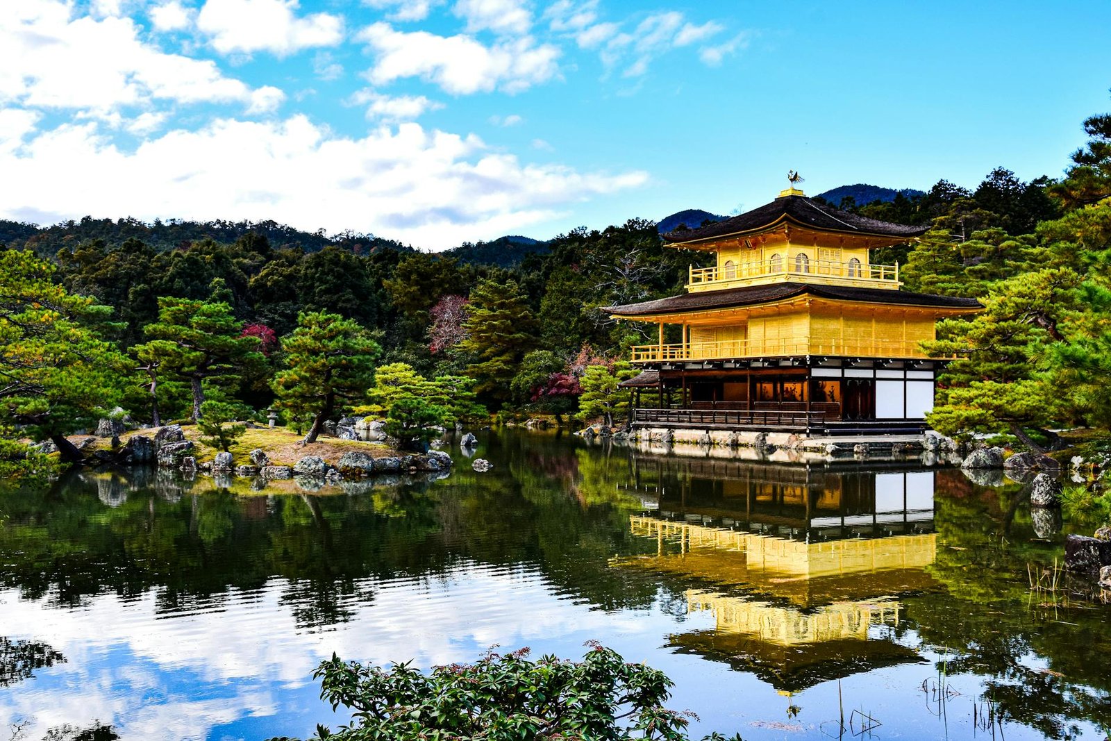 The golden pavilion is surrounded by water and trees