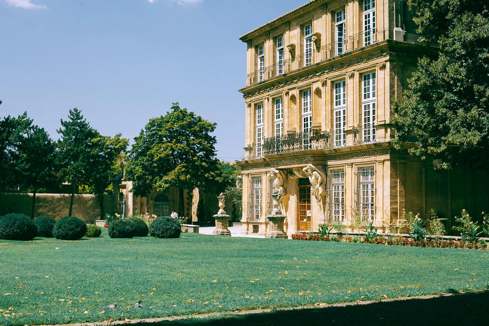 Old building with green lawn and bushes